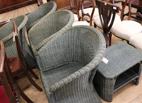 Four green Lloyd Loom armchairs and a coffee table